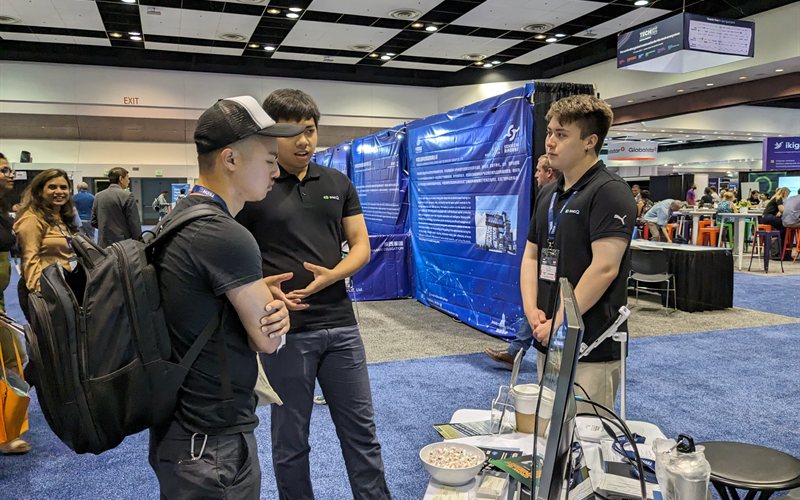 Team chatting with visitors at booth