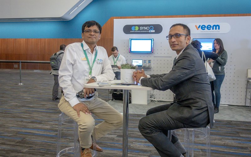 SyncQ founders at conference booth