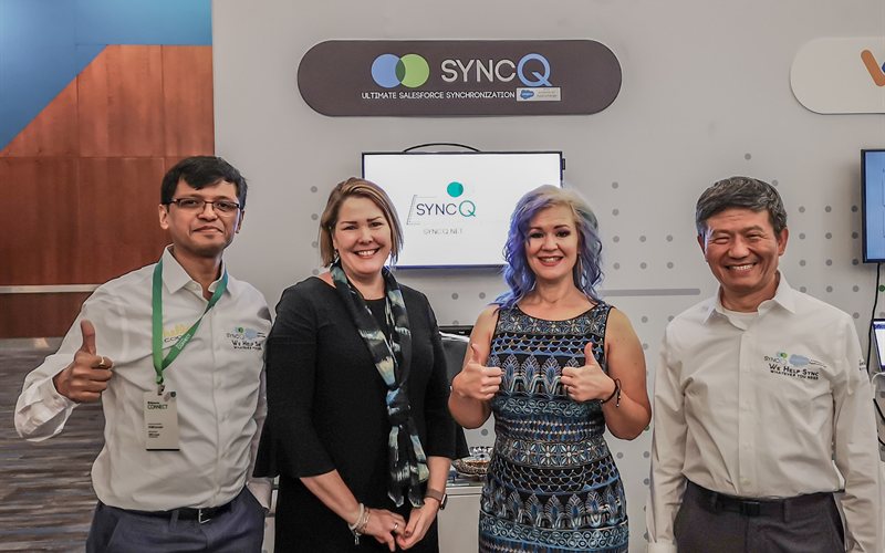 SyncQ team with partners at booth